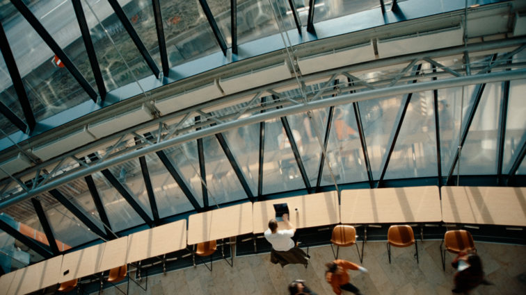 A bird's eye view of the large windows at the front of Visma House in Oslo.