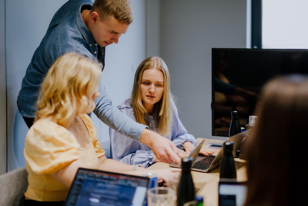 Man and women working together at laptops