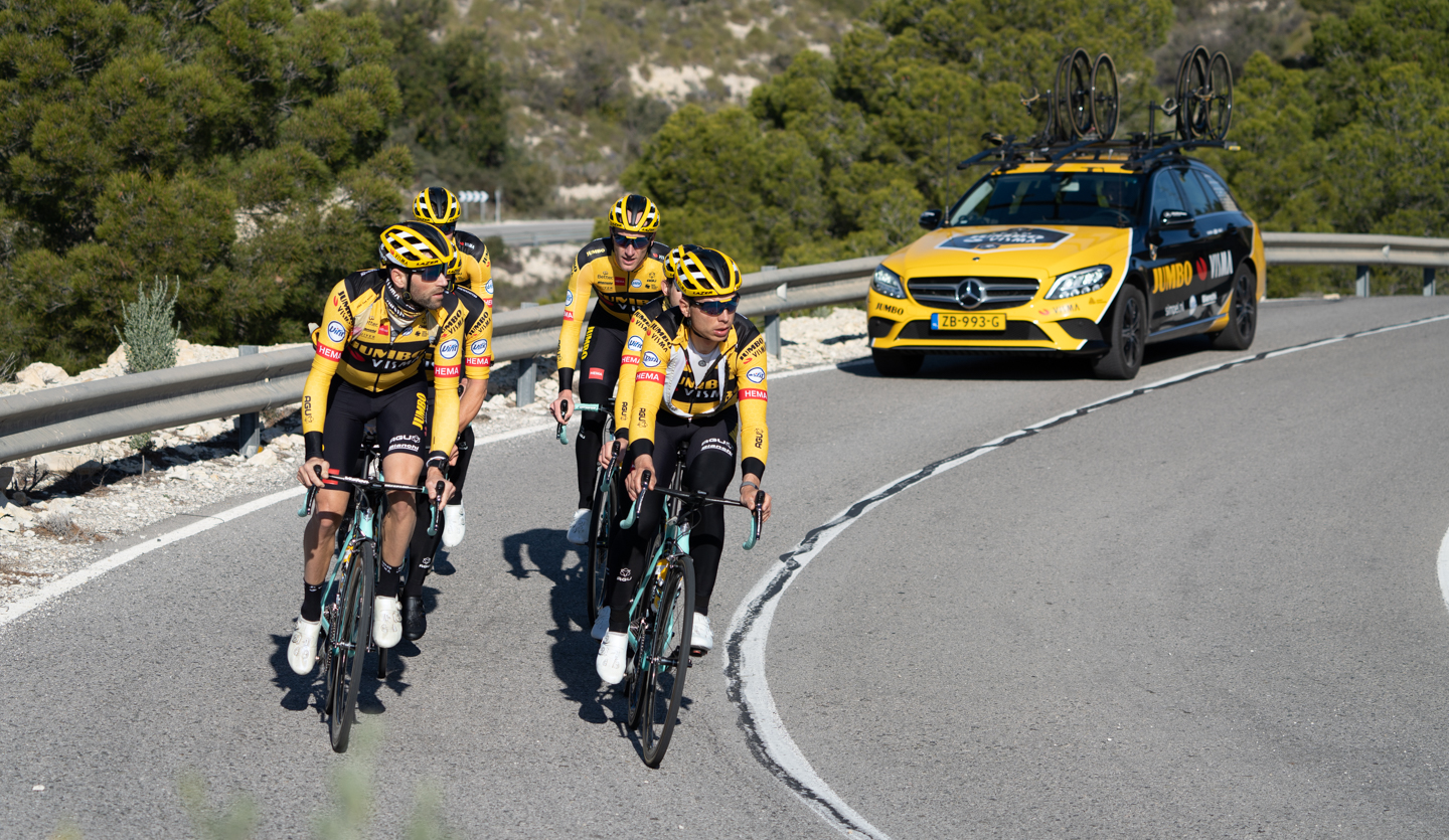 Closeup of the team Jumbo-Visma riders cycling on the road