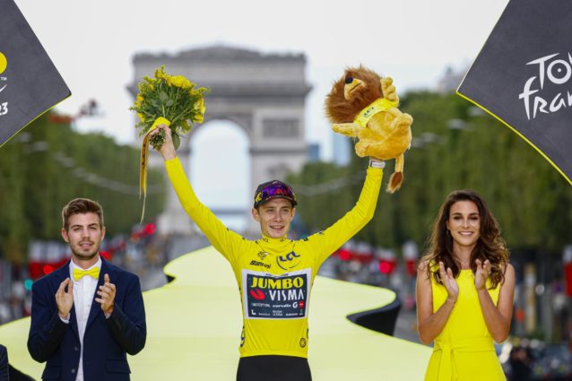 Jonas holding flowers and lion on podium