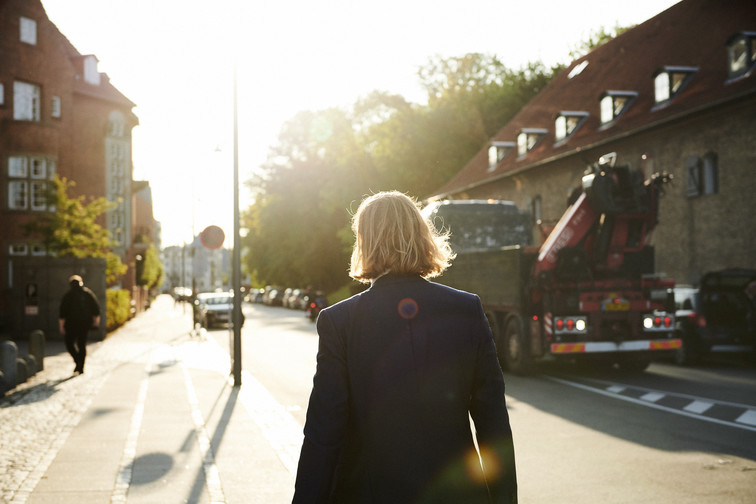 Man walking in a work suit with his back to the camera