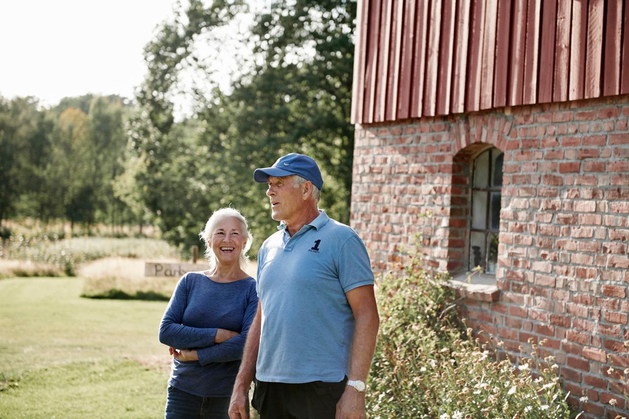 older man and woman talking outside