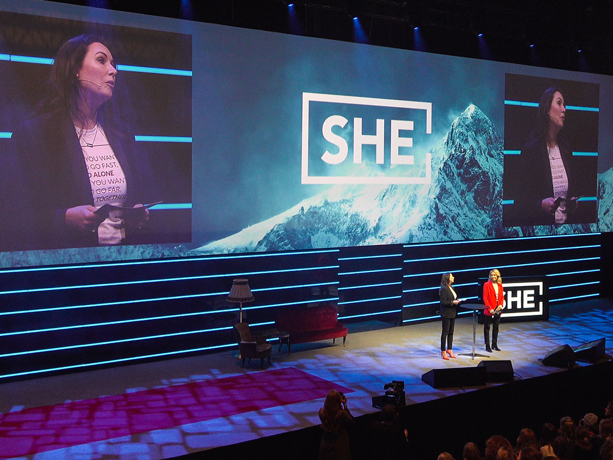 The organisers of She Conference talking on stage