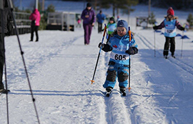 Young boy skiing as part of the Visma Ski Classics for kids event