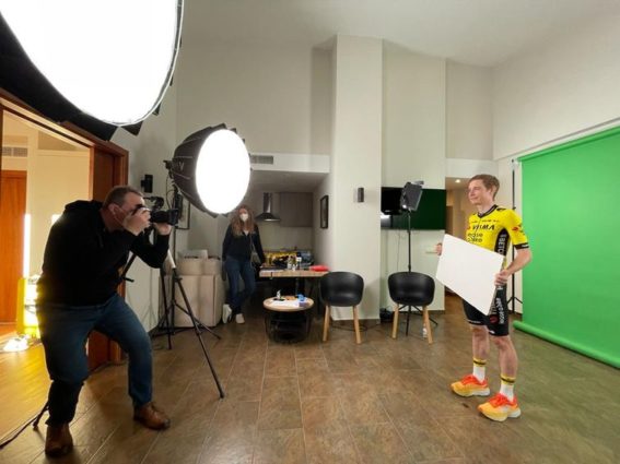 Photographer taking pictures of Jonas Vingegaard in front of green screen